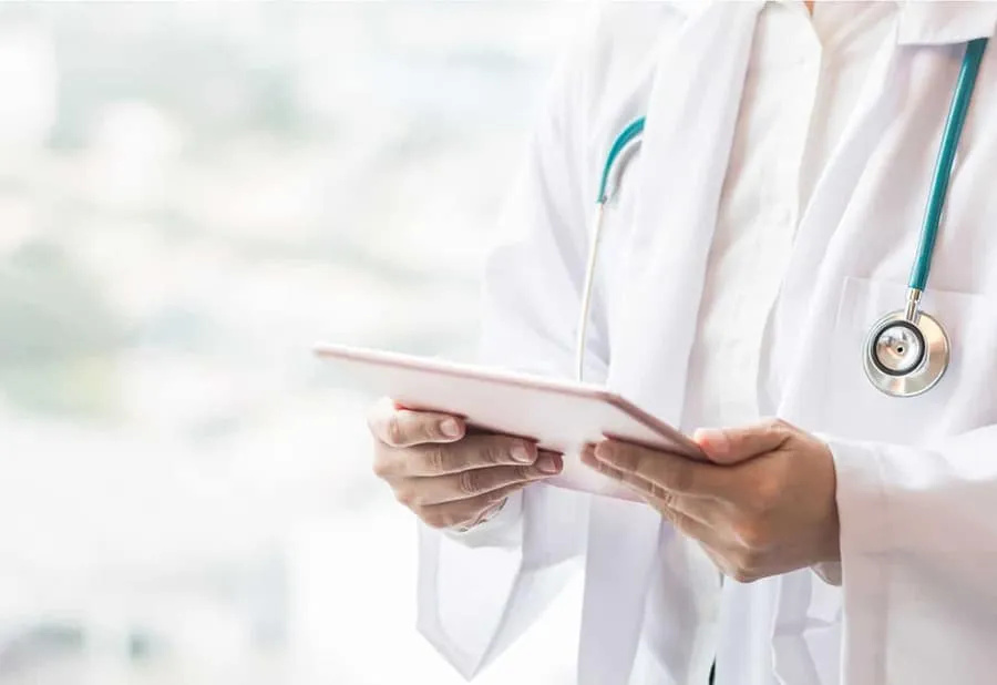 Healthcare professional discussing bone health with a woman in a clinical setting